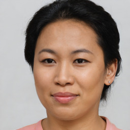 Joyful asian young-adult female with short  brown hair and brown eyes