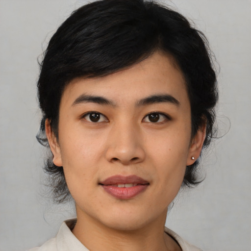 Joyful asian young-adult male with medium  black hair and brown eyes