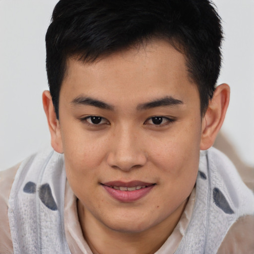 Joyful asian young-adult male with short  brown hair and brown eyes
