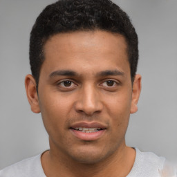 Joyful latino young-adult male with short  brown hair and brown eyes