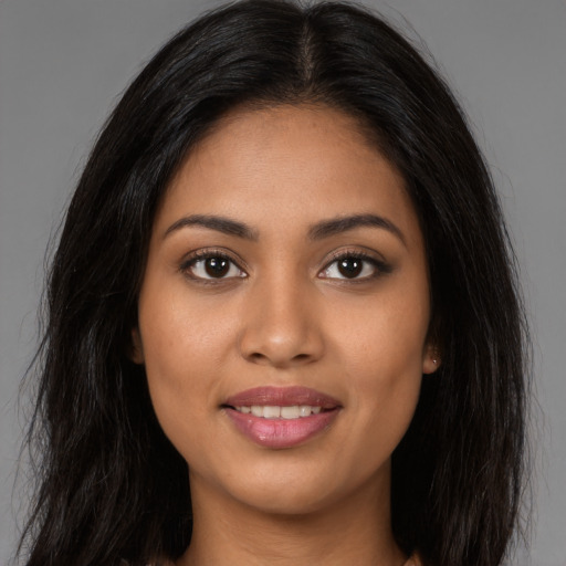 Joyful latino young-adult female with long  brown hair and brown eyes
