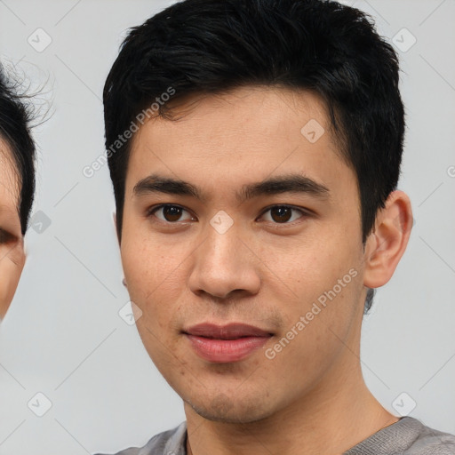 Joyful asian young-adult male with short  brown hair and brown eyes