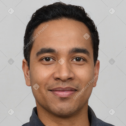 Joyful latino young-adult male with short  black hair and brown eyes