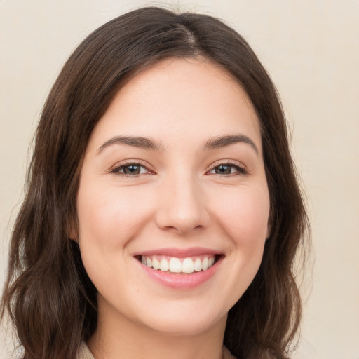 Joyful white young-adult female with medium  brown hair and brown eyes