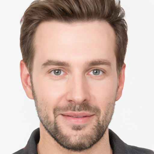 Joyful white young-adult male with short  brown hair and grey eyes