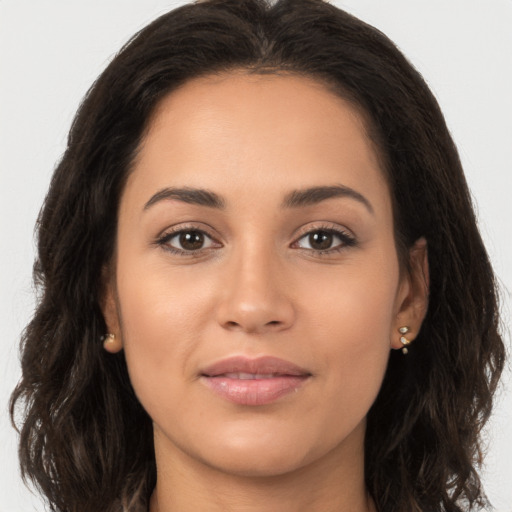 Joyful white young-adult female with long  brown hair and brown eyes