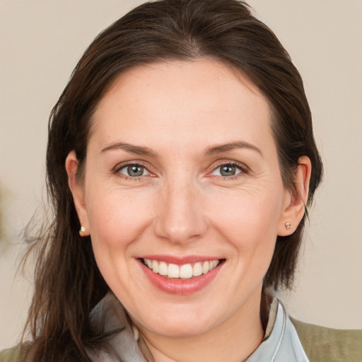 Joyful white adult female with medium  brown hair and brown eyes