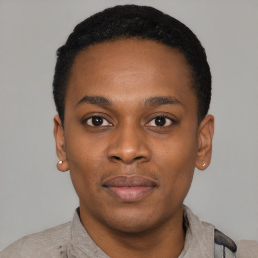 Joyful black young-adult male with short  black hair and brown eyes