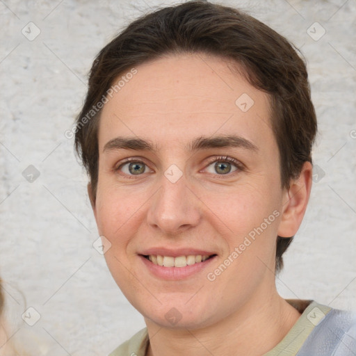 Joyful white young-adult female with short  brown hair and grey eyes