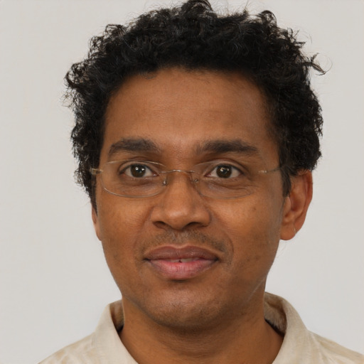 Joyful black adult male with short  brown hair and brown eyes