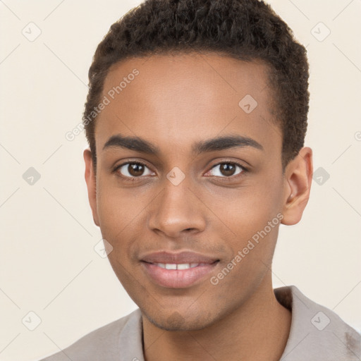 Joyful black young-adult male with short  brown hair and brown eyes