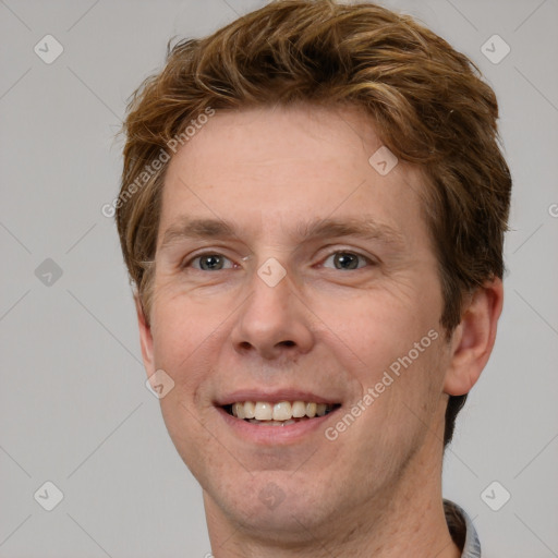 Joyful white adult male with short  brown hair and grey eyes