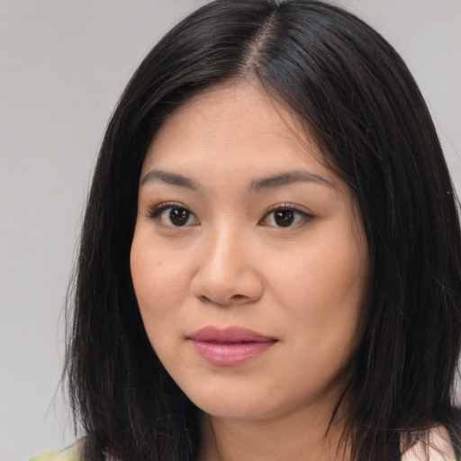 Joyful asian young-adult female with long  black hair and brown eyes