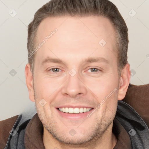 Joyful white adult male with short  brown hair and brown eyes