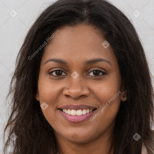 Joyful black young-adult female with long  brown hair and brown eyes