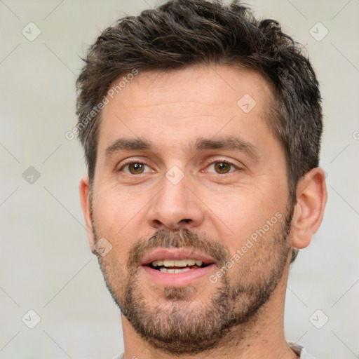 Joyful white adult male with short  brown hair and brown eyes