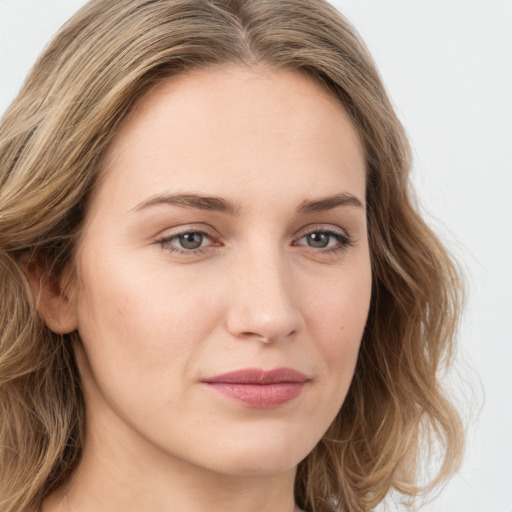 Joyful white young-adult female with long  brown hair and green eyes