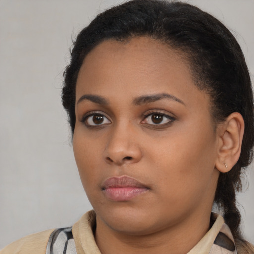 Neutral black young-adult female with medium  brown hair and brown eyes