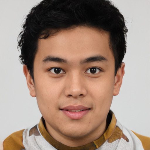 Joyful latino young-adult male with short  brown hair and brown eyes