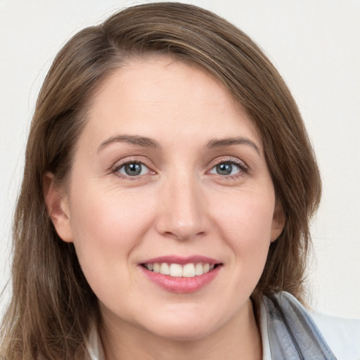 Joyful white young-adult female with long  brown hair and grey eyes