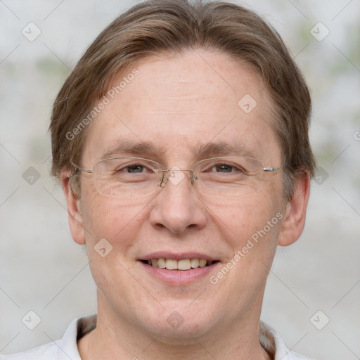 Joyful white adult male with short  brown hair and grey eyes