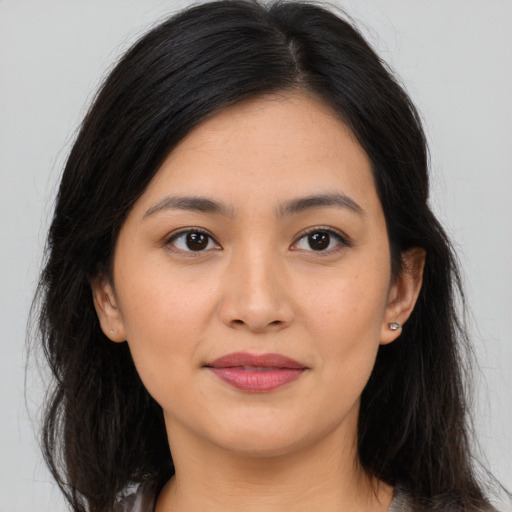 Joyful asian young-adult female with long  brown hair and brown eyes