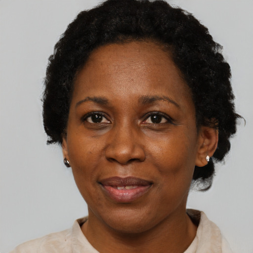 Joyful black adult female with short  black hair and brown eyes
