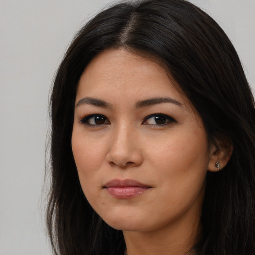 Joyful asian young-adult female with long  brown hair and brown eyes
