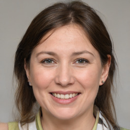 Joyful white adult female with medium  brown hair and brown eyes