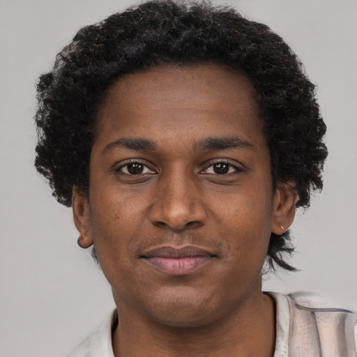 Joyful black young-adult male with short  brown hair and brown eyes