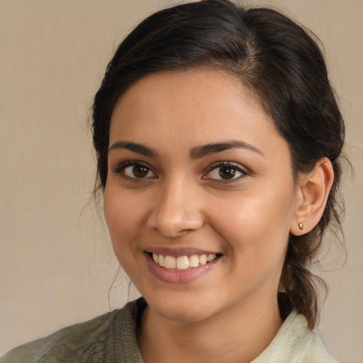 Joyful white young-adult female with medium  brown hair and brown eyes