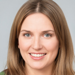 Joyful white young-adult female with long  brown hair and green eyes