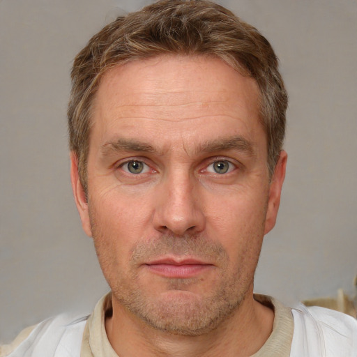 Joyful white adult male with short  brown hair and grey eyes