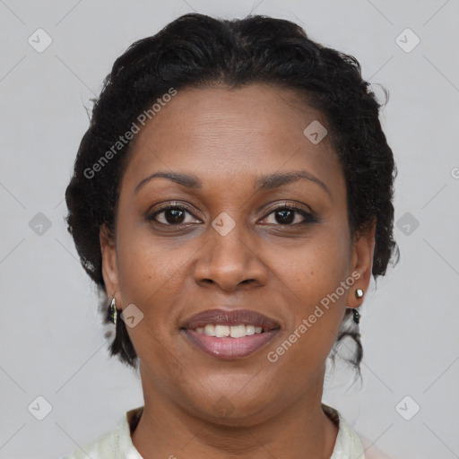 Joyful black adult female with short  brown hair and brown eyes