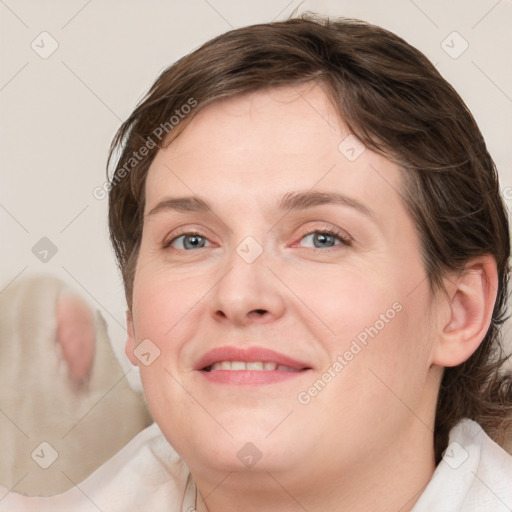 Joyful white adult female with medium  brown hair and blue eyes