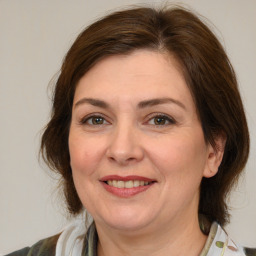 Joyful white adult female with medium  brown hair and brown eyes