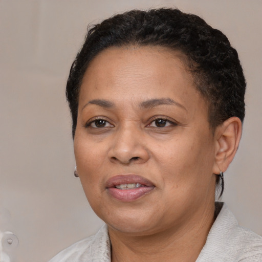 Joyful black adult female with short  brown hair and brown eyes