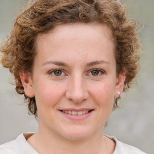 Joyful white young-adult female with short  brown hair and blue eyes