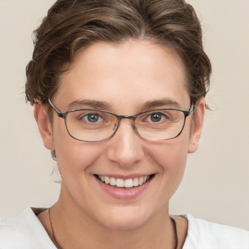 Joyful white young-adult female with short  brown hair and grey eyes