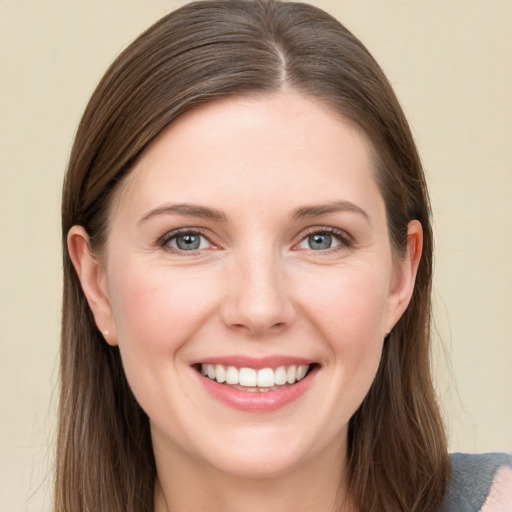 Joyful white young-adult female with long  brown hair and grey eyes