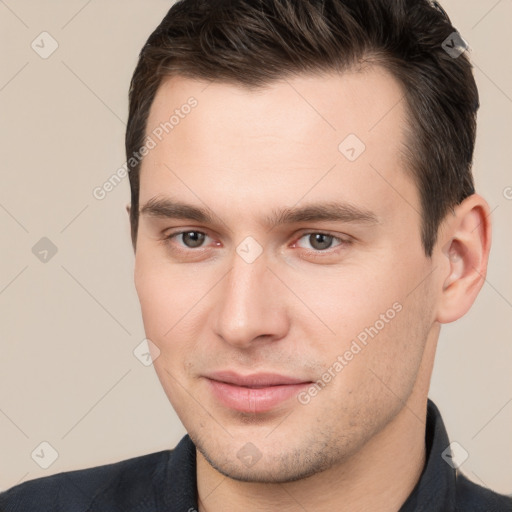 Joyful white young-adult male with short  brown hair and brown eyes