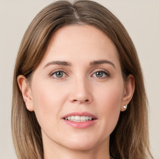 Joyful white young-adult female with long  brown hair and grey eyes