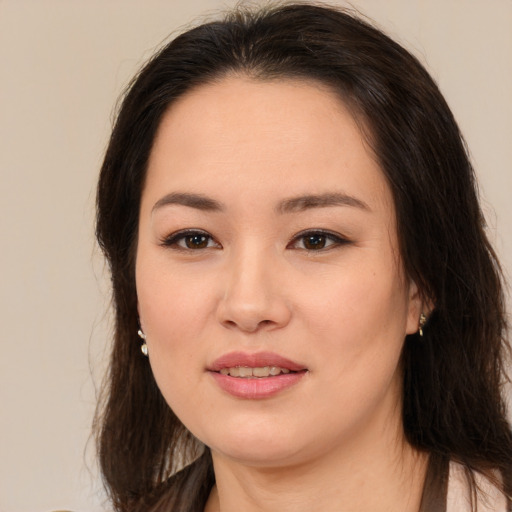 Joyful white young-adult female with long  brown hair and brown eyes