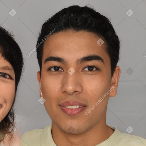 Joyful asian young-adult male with short  brown hair and brown eyes