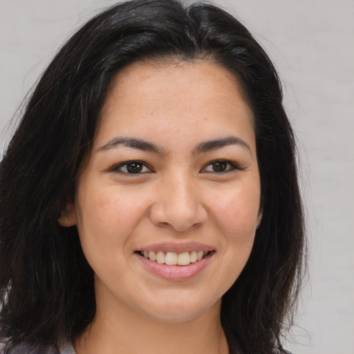 Joyful white young-adult female with long  brown hair and brown eyes