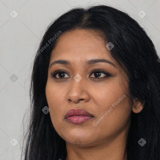 Joyful latino young-adult female with long  black hair and brown eyes