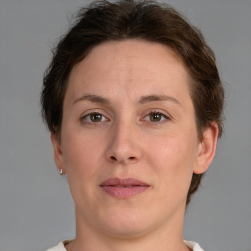 Joyful white adult female with short  brown hair and brown eyes