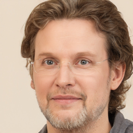 Joyful white adult male with short  brown hair and grey eyes