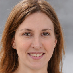 Joyful white adult female with long  brown hair and blue eyes