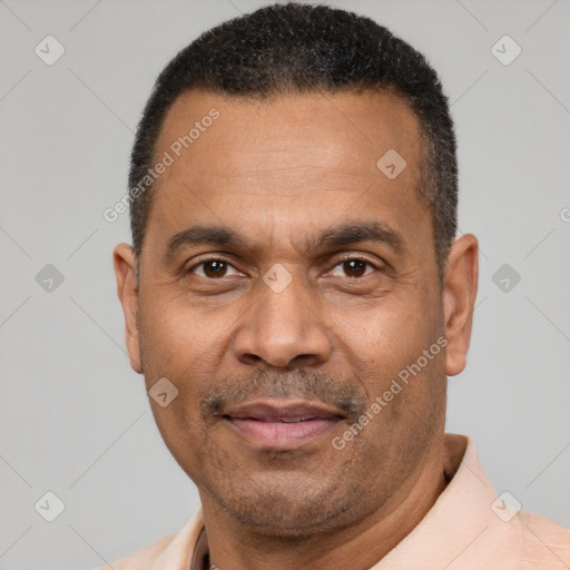 Joyful latino adult male with short  black hair and brown eyes